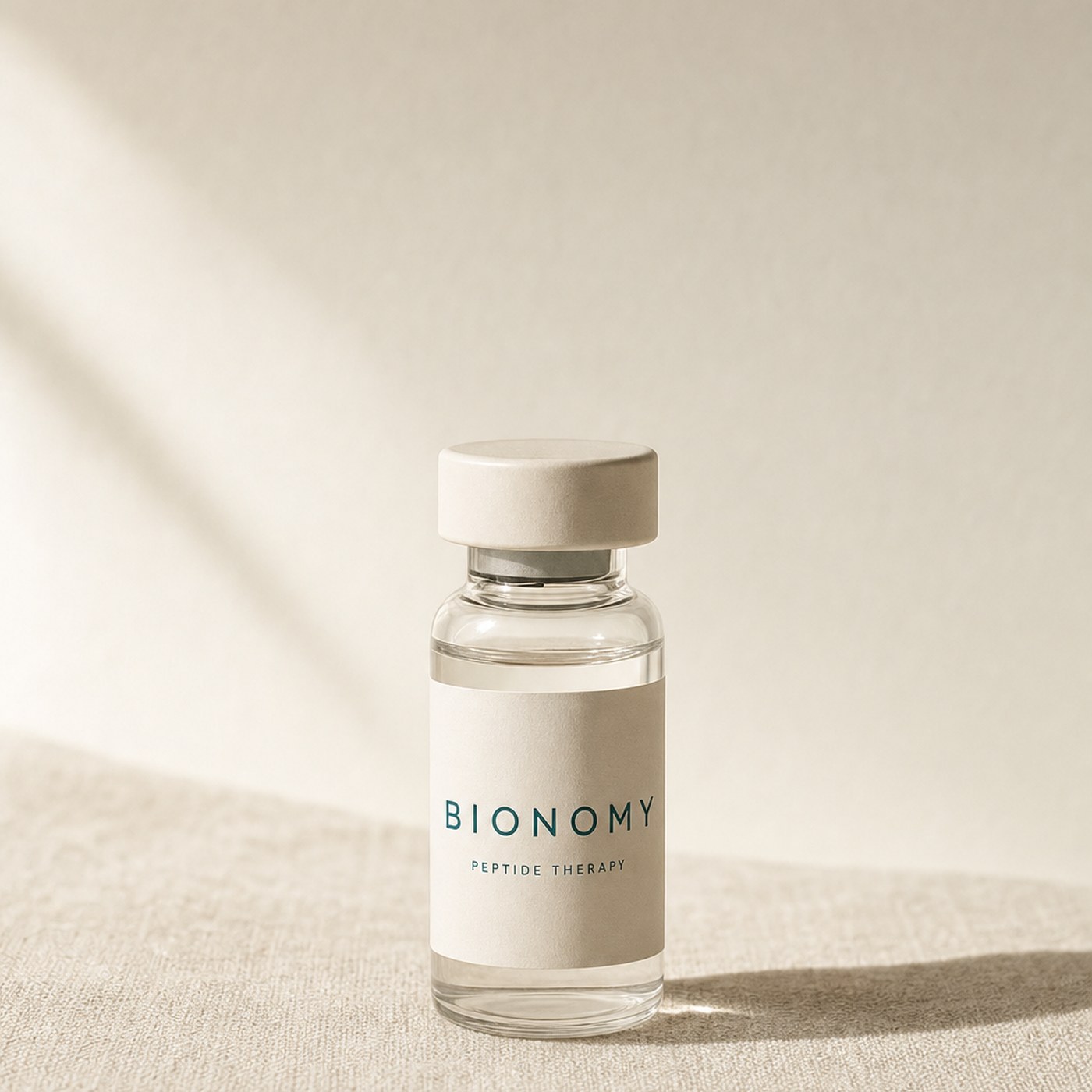 Glossy amber GLP-1 vial on cream surface